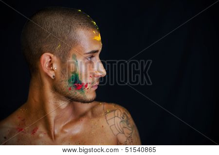 Profile Of Young Man Painted And Sprayed With Honi Color On His Skin