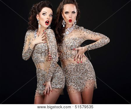 Soiree. Two Young Surprised Women Over Black