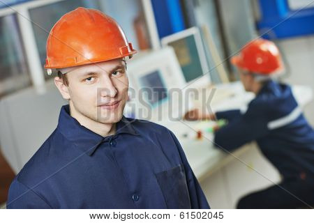 portrait of positive adult industrial worker at factory workshop