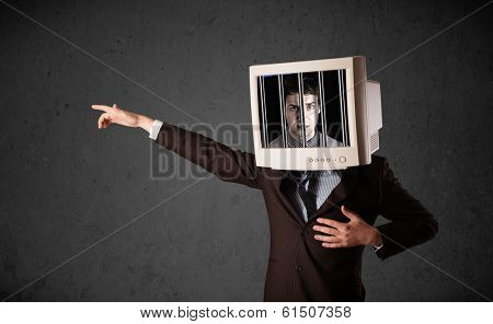 Business man with monitor screen on his head traped into a digital system concept