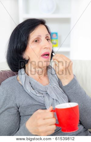 Senior taking pills at home