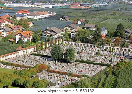 Friedhof (cemetery, graveyard) surrounded by Apple Orchard in Trentino-Alto Adige, Italy 