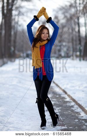 Portrait of a girl in the mittens on the street