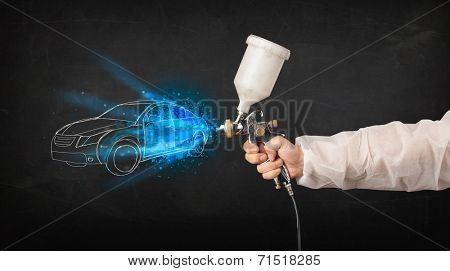 Worker with airbrush gun painting hand drawn white car lines