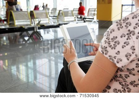 Digital tablet or e-reader at the departure gate of an airport
