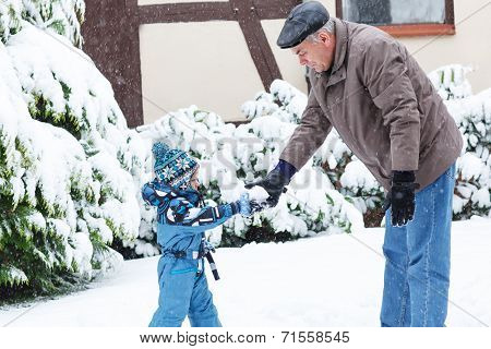 Grandfather And Toddler Boy  On Winter Day