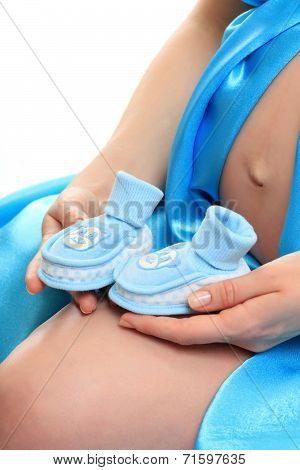 Pregnant belly with blue booties