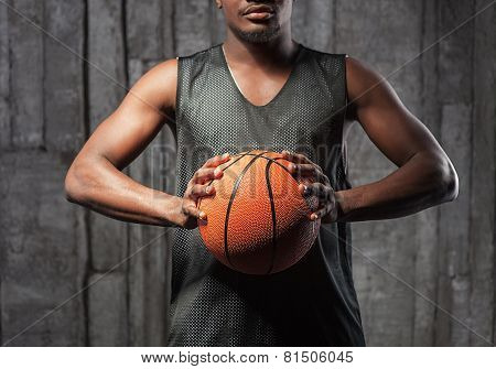 Afro-american basketball athlete gripping the ball