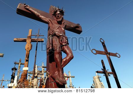 SIAULIAI, LITHUANIA - AUGUST 1, 2013: Wooden Crucifix at the Hill of Crosses, the most important Lithuanian Catholic pilgrimage site located near the town of Siauliai in Northern Lithuania.