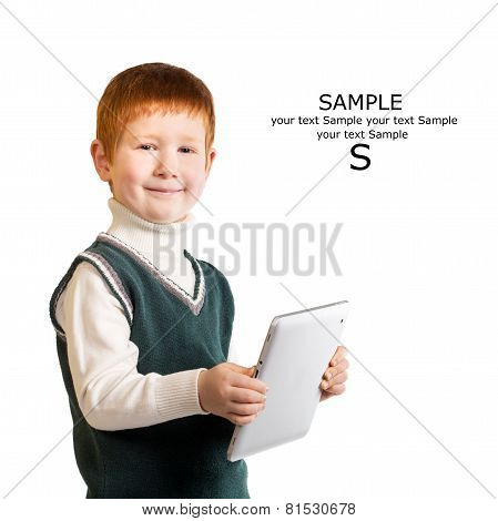 Cute Red Haired Child Stands With A Tablet Pc. Isolated At The White Background. Place For Your Text