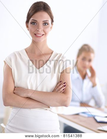 Attractive businesswoman with her arms crossed stnding