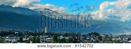 Dali old town rooftop view with cloudy Mt Cangshan. Yunnan, China.