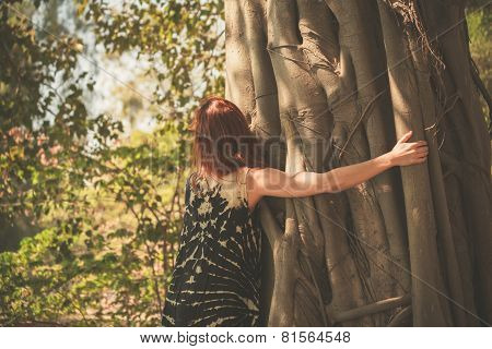 Woman Hugging A Giant Tree