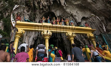 KUALA LUMPUR, MALAYSIA - JANUARY 31, 2015: Hindu devotees walk up the Sri Mahamarriamman temple built inside a limestone cave. Hundreds of thousands of devotees gather here for the Thaipusam prayers.