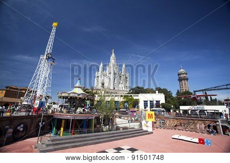 BARCELONA, SPAIN - MAY 2, 2015:  Amusement Park and Church of the Sacred Heart of Jesus on Mount Tibidabo in Barcelona, Catalonia, Spain