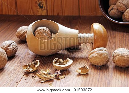 Wooden Nutcracker And  Walnuts On A Wooden Table