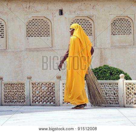Woman Of Fourt Class In Brightly Colored Clothing Cleans The Palace In Amber