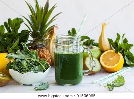 Fresh kale fruit smoothie in a jar with ingredients