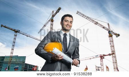 Successful Engineer Or Architect, Crane And Building Construction At Backgrpound. Joyous Businessman