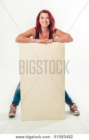 Young smiling woman holding a blank white banner