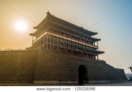 Beijing, China at the Zhengyangmen Gatehouse in Tiananmen Square. Beautiful historical building at sunset.
