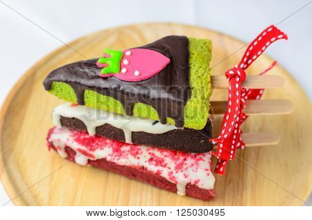 Home made brownies winter tree shape with red bow and ribbon on wooden plate