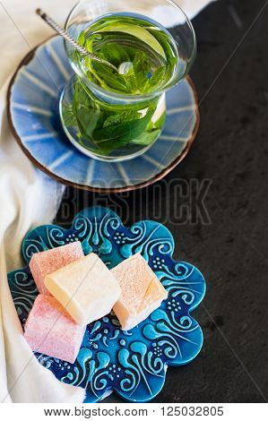 Traditional turkish dessert - mint tea and bakhlava on rustic background