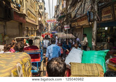 DELHI INDIA - 19TH MARCH 2016: Bad congestion down a street in Delhi. People Tuk Tuks and buildings can be seen.