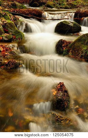 Spring flowing mountain stream waterfall in Slovakia