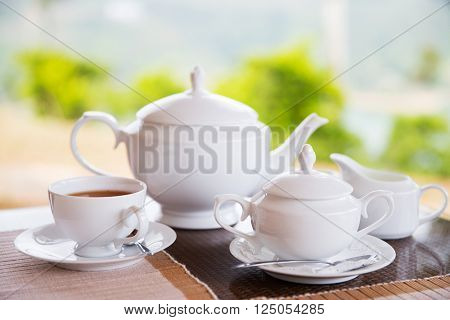 teatime, drink and object concept - close up of tea service on table at restaurant or teahouse