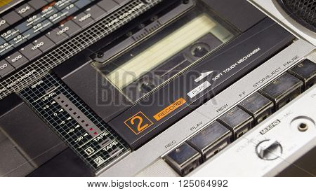 Old and  retro audio cassete player with the open deck and cassette inside