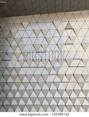 Abstract close-up view of modern aluminum ventilated facade of triangles