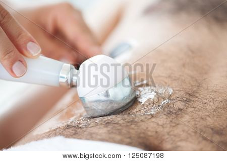 Applying an ultrasonic sound (Ultrasound) Treatment on male patient