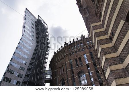 VIENNA, AUSTRIA - MAY 7: Modern buildings in front of Gasometers of Vienna in Austria on 7 May 2012 in Vienna, Austria.