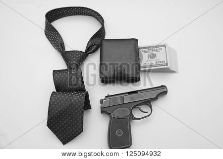 composition of objects as a purse full of bills tie semiautomatic weapons.