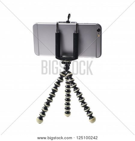 Smartphone set up on a tripod isolated over the white background