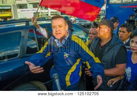 Quito, Ecuador - April 7, 2016: Closeup opposition leader Andres Paez surrounded by people, police and journalists during anti government protests in Shyris Avenue.