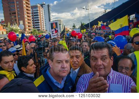 Quito, Ecuador - April 7, 2016: Closeup opposition leader Andres Paez surrounded by people, police and journalists during anti government protests in Shyris Avenue.