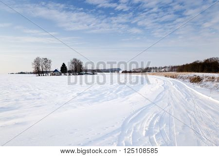 A Small Country Road Passes In A Field In Winter. Covered With Snow