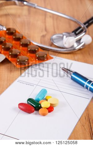 Medical pills tablets or supplements for therapy prescription and stethoscope on desk in doctor office concept of treatment and health care