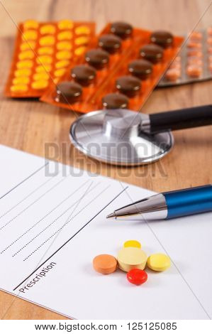 Medical pills tablets or supplements for therapy prescription and stethoscope on desk in doctor office concept of treatment and health care