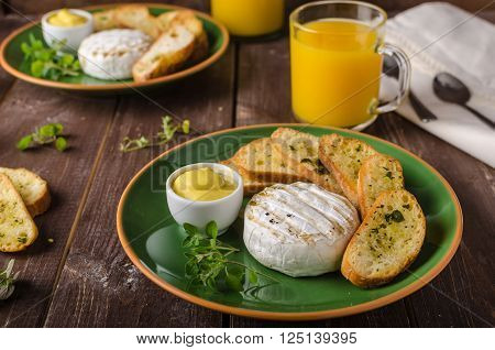 Grilled camembert with toast and juice fresh toasted baquette with herbs and delicious dijon mustard. Beautiful melted cheese.