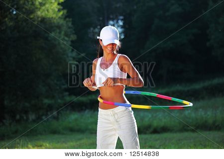 woman rotates hula hoop