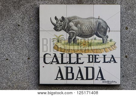 MADRID, SPAIN - MARCH 13, 2016: Closeup of the street sign in Madrid. They are hand-painted ceramic tiles typically composed within 9 or 12 tiles. They depict the name of the alley or street as well as illustrations that indicate special meanings.