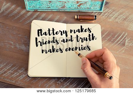 Handwritten quote Flattery makes friends and truth makes enemies as inspirational concept image