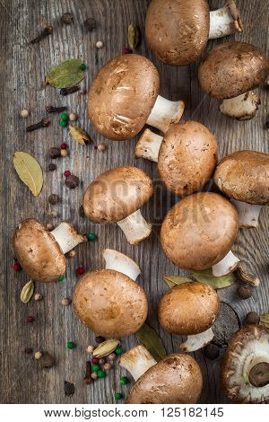 Mushrooms Champignons And Spices On Wooden Table. Top View.