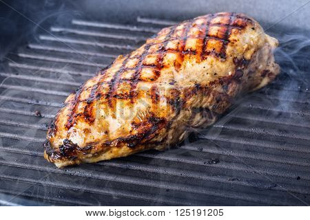Grilled chicken breast in different variations with cherry tomatoes mushrooms herbs cut lemon on a wooden board or grill pan. Traditional cuisine. Grill kitchen