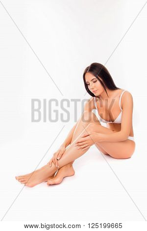 Beautiful Sensual Woman In White Underwear Doing Massage For Her Legs