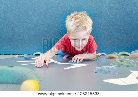 Child on a climbing wall in a park