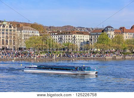 Zurich, Switzerland - 10 April, 2016: view on Utoquai quay across Lake Zurich with MS. Regula passing. Zurich is the largest city in Switzerland and the capital of the Swiss canton of Zurich.